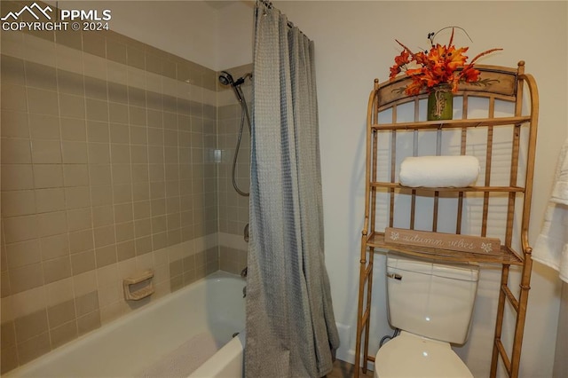 bathroom featuring shower / bath combo and toilet