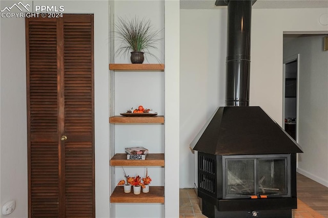 details featuring wood-type flooring and a wood stove