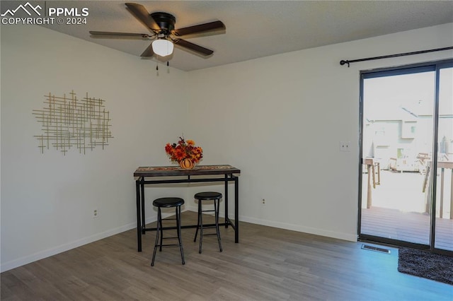 dining area featuring a healthy amount of sunlight, ceiling fan, and hardwood / wood-style flooring