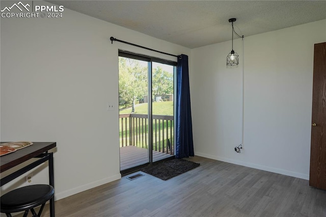 entryway with a textured ceiling and hardwood / wood-style flooring