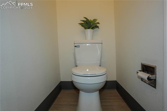 bathroom featuring hardwood / wood-style floors and toilet