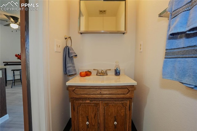 bathroom with ceiling fan, vanity, and hardwood / wood-style floors