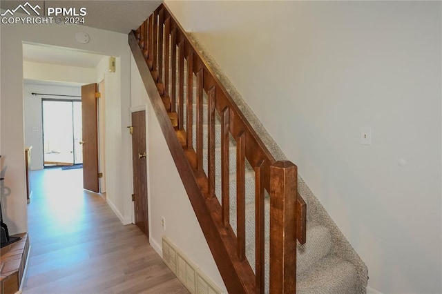 stairs with wood-type flooring