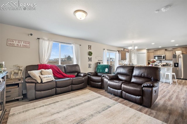 living room featuring hardwood / wood-style floors and a chandelier