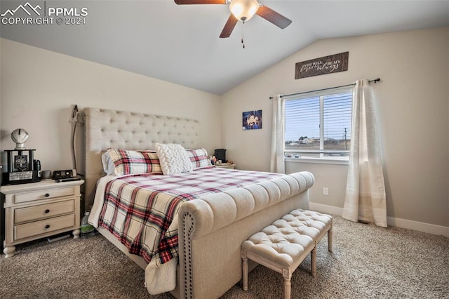 bedroom with vaulted ceiling, dark colored carpet, and ceiling fan