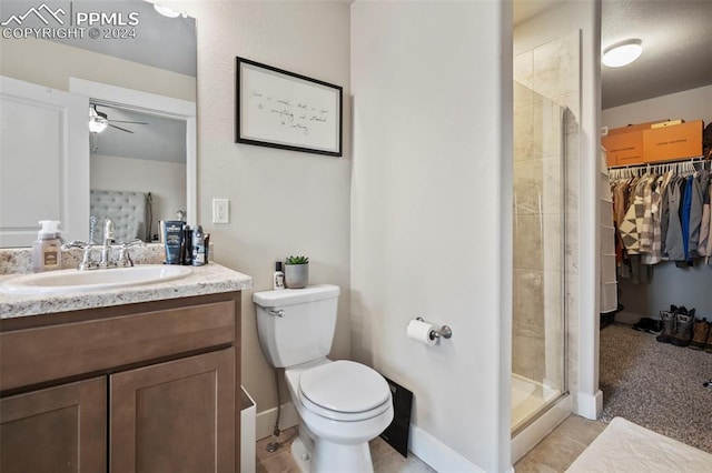 bathroom with vanity, ceiling fan, an enclosed shower, toilet, and tile patterned floors