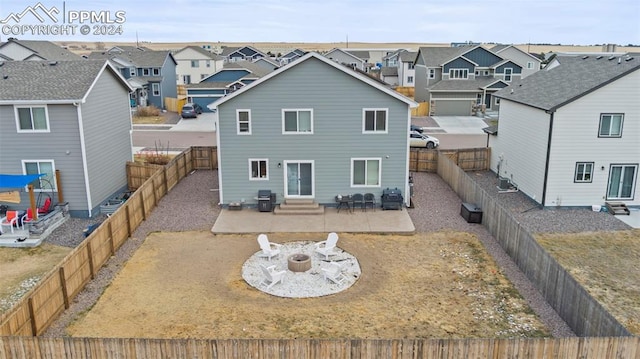 back of house featuring an outdoor fire pit and a patio area