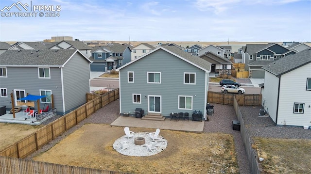 rear view of house with a fire pit, a patio area, and central air condition unit