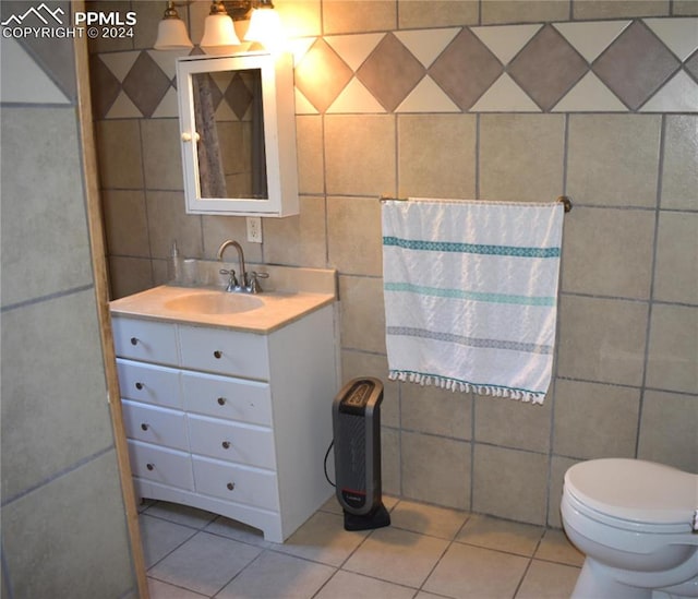 bathroom with vanity, tile walls, toilet, and tile patterned floors