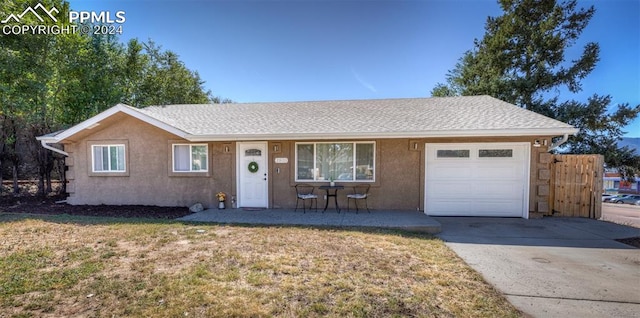 ranch-style house featuring a garage and a front yard