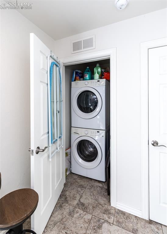 washroom with stacked washer / drying machine