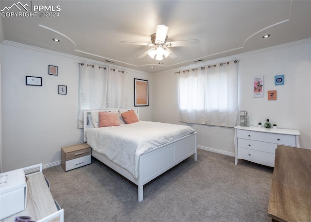 carpeted bedroom with crown molding and ceiling fan