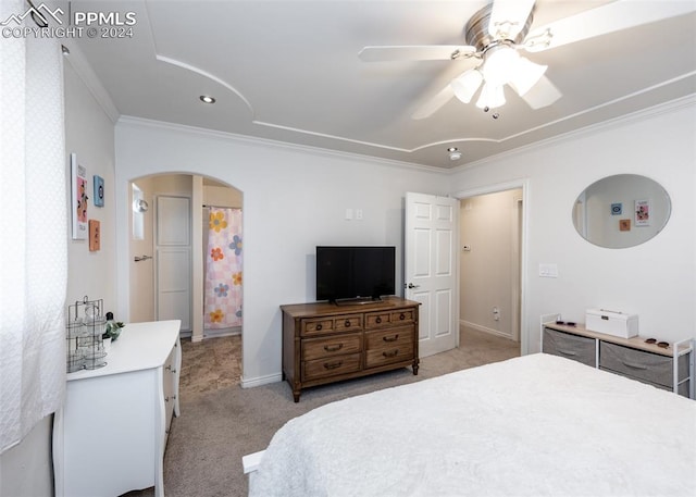 bedroom with crown molding, light colored carpet, and ceiling fan