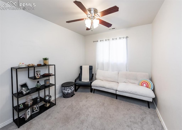 sitting room with light colored carpet and ceiling fan