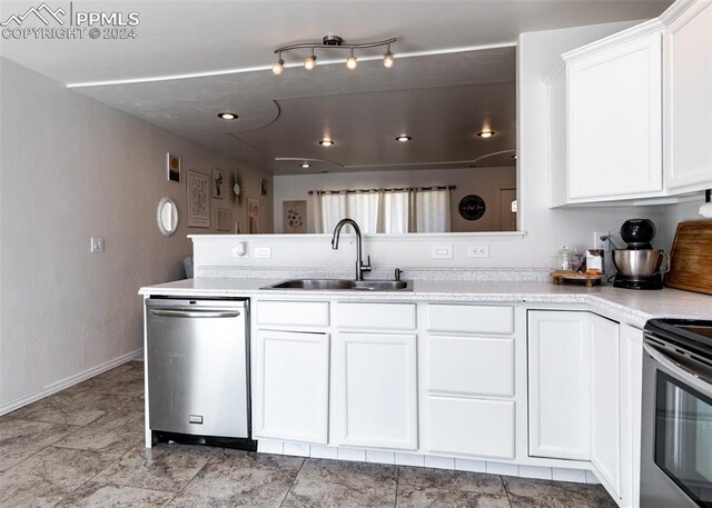 kitchen with stainless steel appliances, sink, and white cabinets