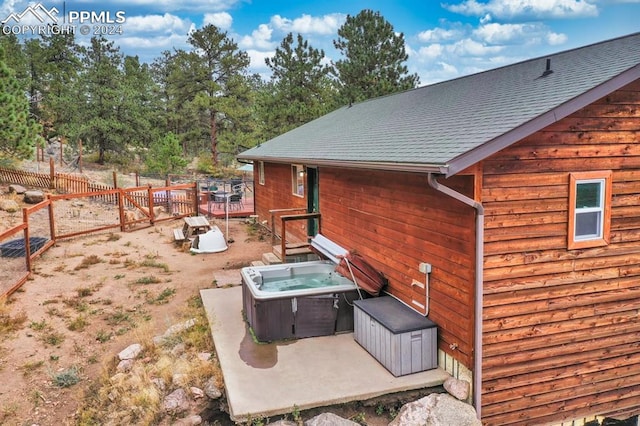 exterior space with a hot tub and a patio area