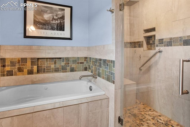 bathroom with separate shower and tub