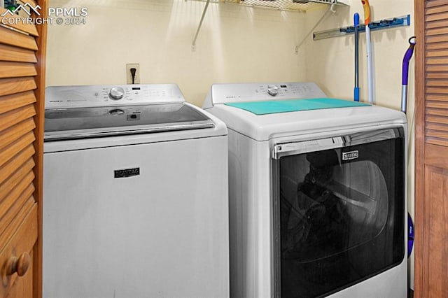 washroom with washing machine and clothes dryer