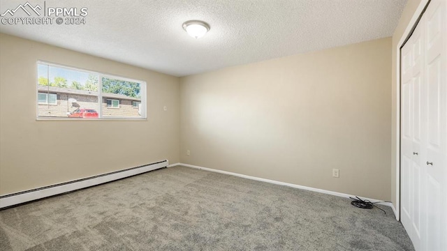 unfurnished bedroom featuring light carpet, a textured ceiling, and a closet