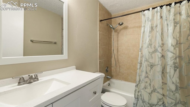 full bathroom with shower / bath combo with shower curtain, a textured ceiling, vanity, and toilet