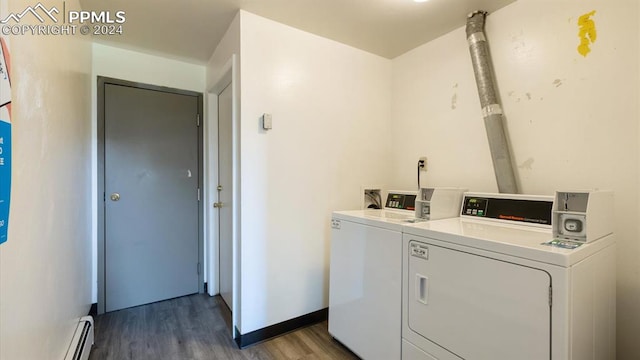 washroom with a baseboard heating unit, hardwood / wood-style floors, and independent washer and dryer