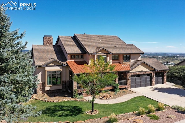 view of front of house featuring a garage and a front lawn