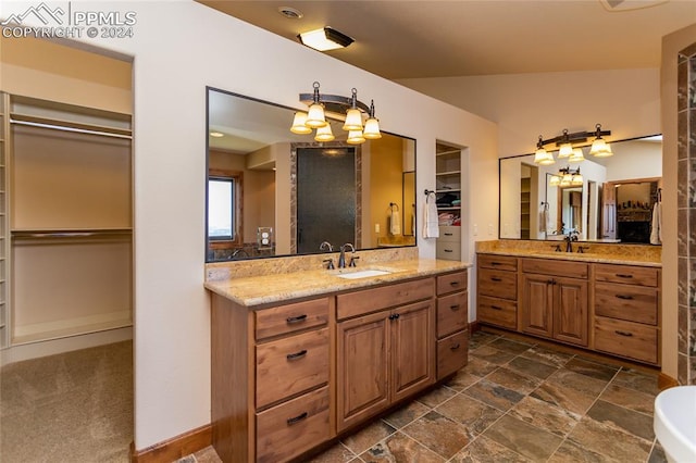 bathroom with vanity and vaulted ceiling