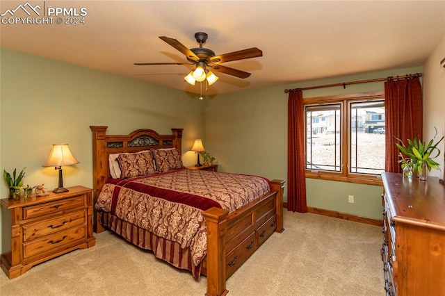 bedroom featuring light carpet and ceiling fan