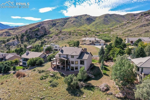 birds eye view of property featuring a mountain view