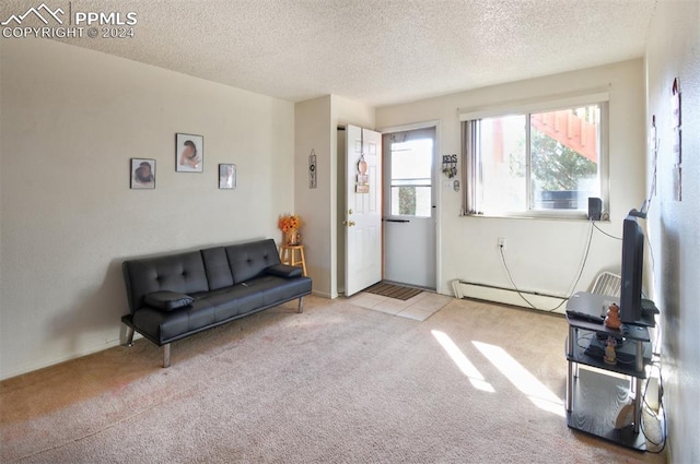 living area with light colored carpet, a baseboard radiator, and a textured ceiling