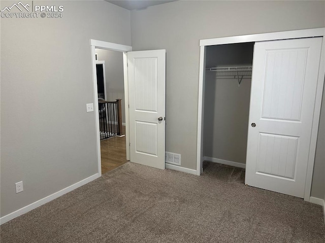 unfurnished bedroom with carpet floors and a closet