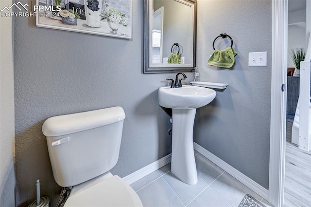 bathroom featuring toilet and tile patterned floors