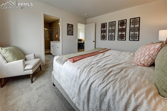 bedroom featuring connected bathroom and light carpet