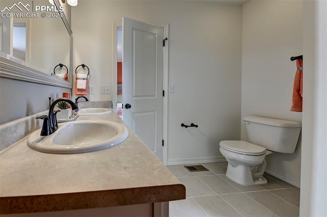 bathroom featuring tile patterned floors, vanity, and toilet