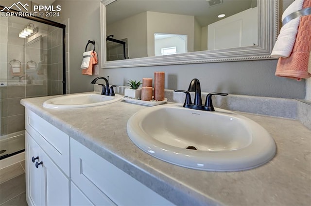 bathroom featuring vanity and a shower with door