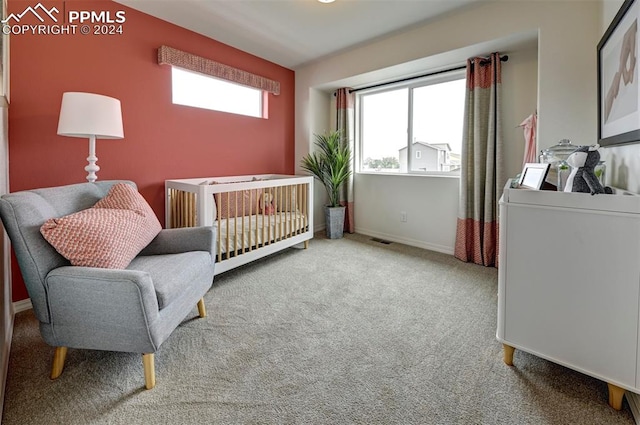 carpeted bedroom with a crib