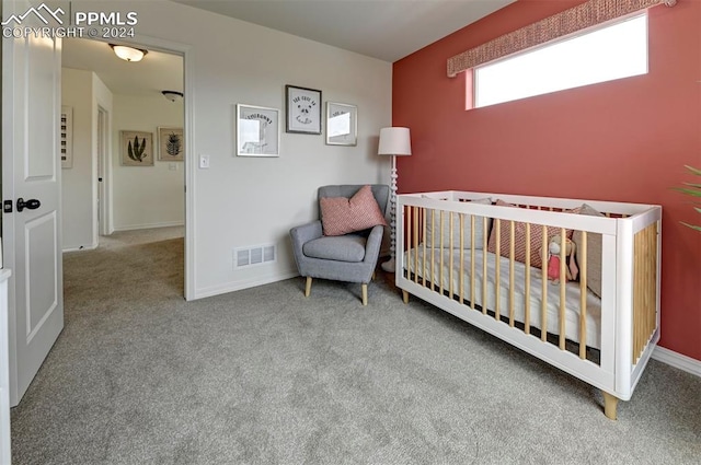 carpeted bedroom with a nursery area