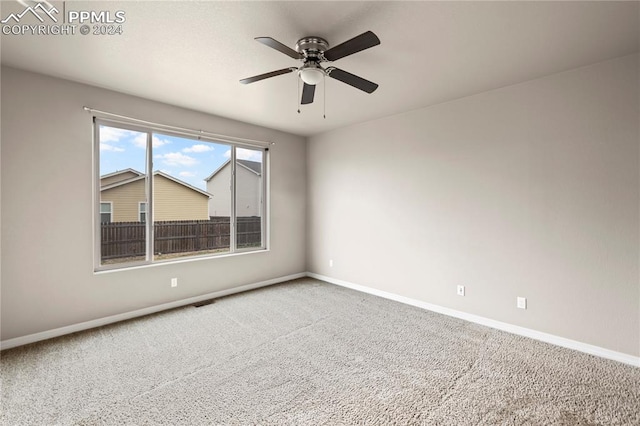 spare room featuring ceiling fan and carpet flooring