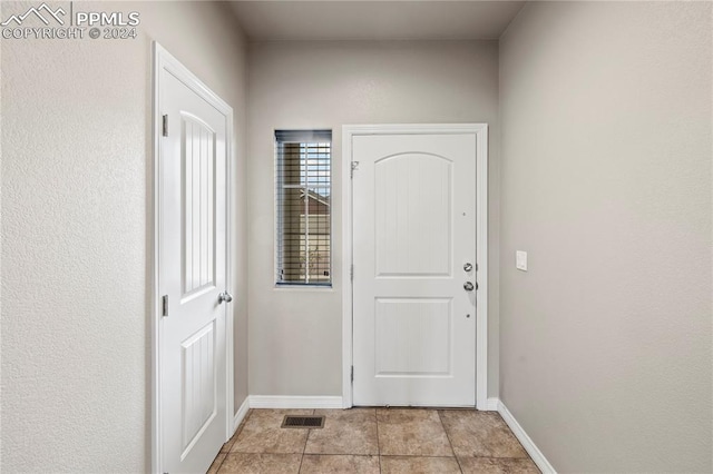 doorway featuring light tile patterned floors