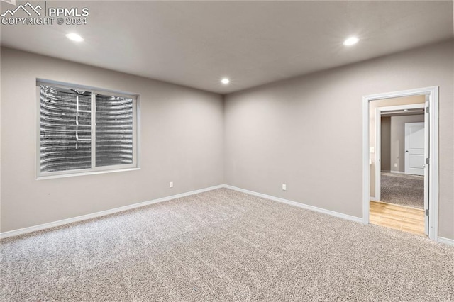 spare room with light colored carpet