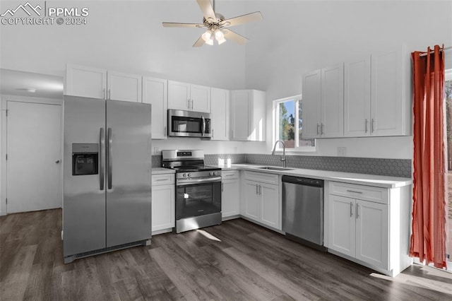 kitchen featuring white cabinetry, dark wood-type flooring, stainless steel appliances, ceiling fan, and sink