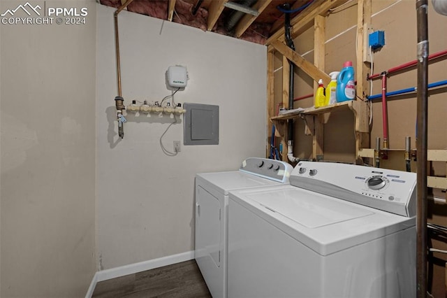 clothes washing area featuring electric panel, independent washer and dryer, and dark wood-type flooring