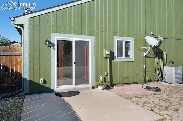 entrance to property with a patio and central AC