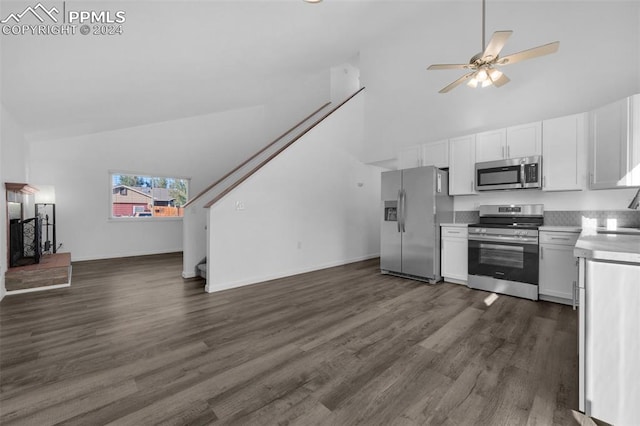 kitchen with appliances with stainless steel finishes, dark wood-type flooring, ceiling fan, and white cabinets