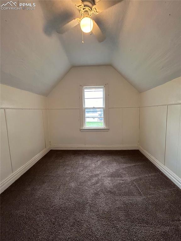 additional living space featuring ceiling fan, lofted ceiling, and carpet