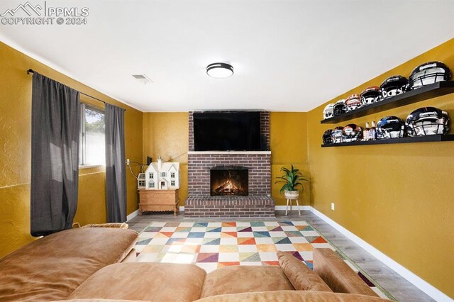 living room with a brick fireplace