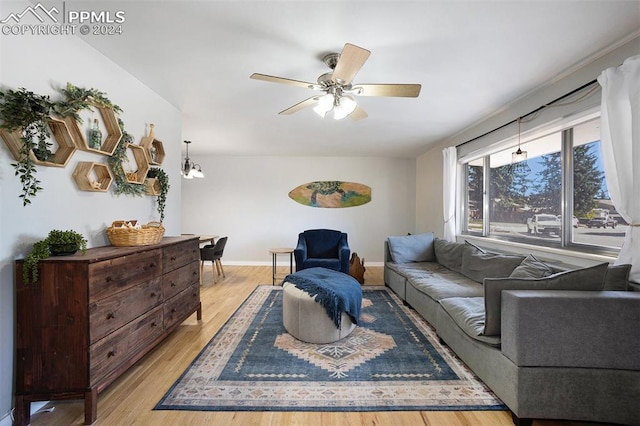 living room featuring ceiling fan and light hardwood / wood-style flooring