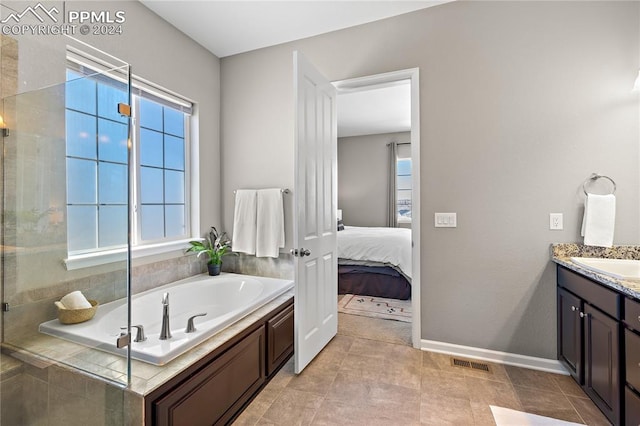 bathroom featuring vanity, separate shower and tub, and tile patterned floors