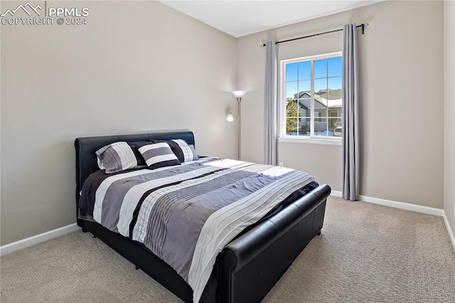 bedroom featuring light colored carpet