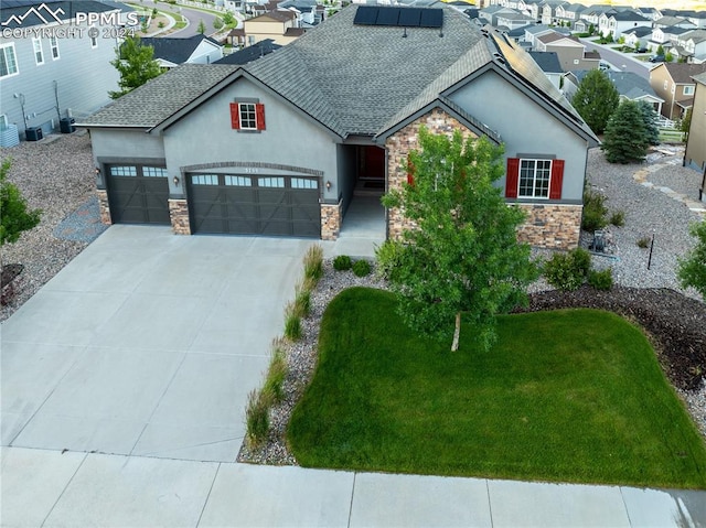 view of front of home with a front yard and a garage